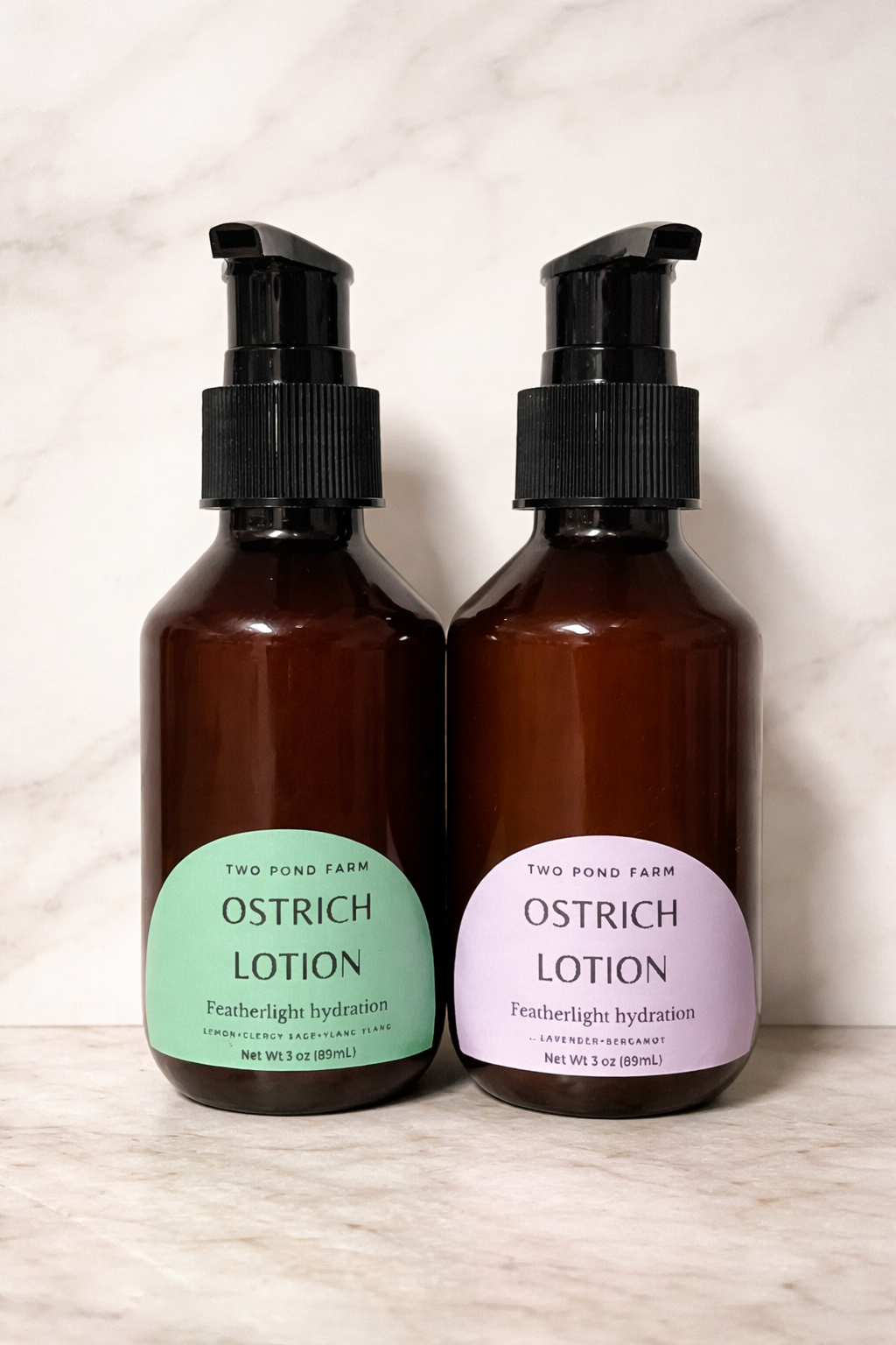Two bottles of Ostrich Lotion from Two Pond Farm on a light background