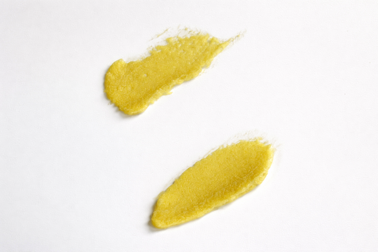 Two balm swatches on a white background